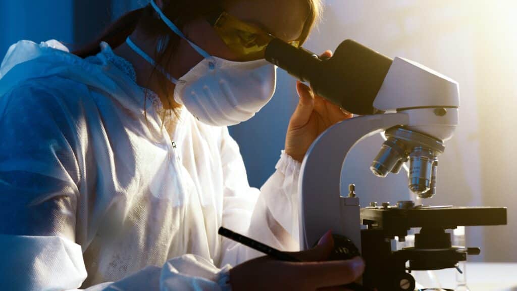 Female looking into microscope