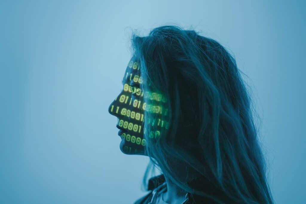 Girl with green code projected onto face